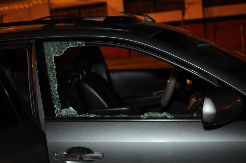 A shattered car window at night